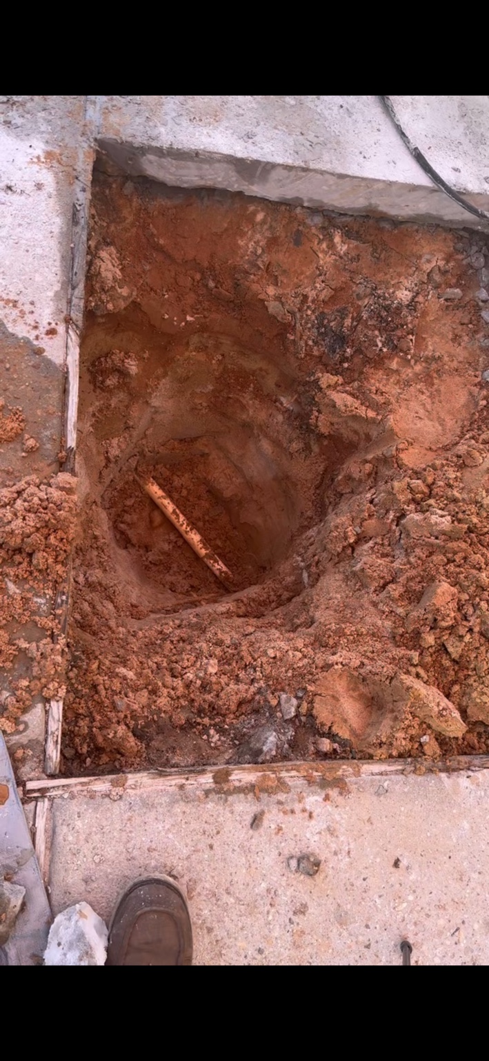 Water line exposed at the leak location beneath concrete