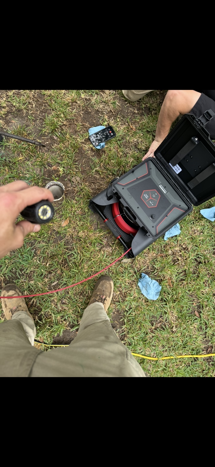 Technicians performing a sewer camera inspection